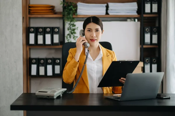asian businesswoman have the joy of talking on  phone in the modern office