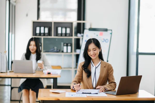 stock image Young attractive Asian female office workers  at camera in office