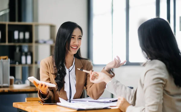 stock image Kind leader executive manager share and discuss business solutions plan ideas  with Asian female marketing manager in modern office.