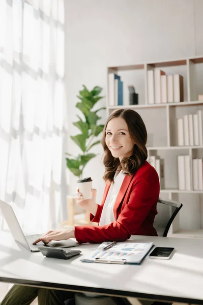 stock image Confident woman with a smile  holding coffee at the modern office
