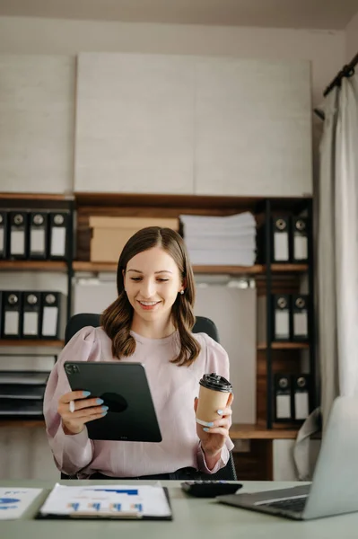 Confident business expert ,attractive  young woman  holding digital tablet   in creative office