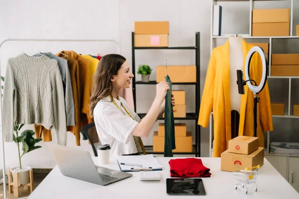 Stock image Asian tailor woman working on clothes in tailoring atelier.  beautiful young female fashion designer in office