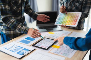 Close up view of UI developer team brainstorming on their project with laptop. Creative digital development agency. in office