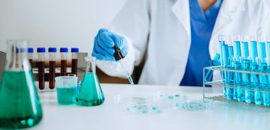 Scientist mixing chemical liquids in the chemistry lab. Researcher working in the chemical laboratory. 