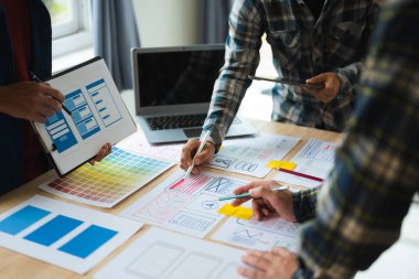 Close up view of UI developer team brainstorming on their project with laptop. Creative digital development agency. in office