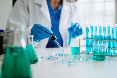 Scientist mixing chemical liquids in the chemistry lab. Researcher working in the chemical laboratory. 