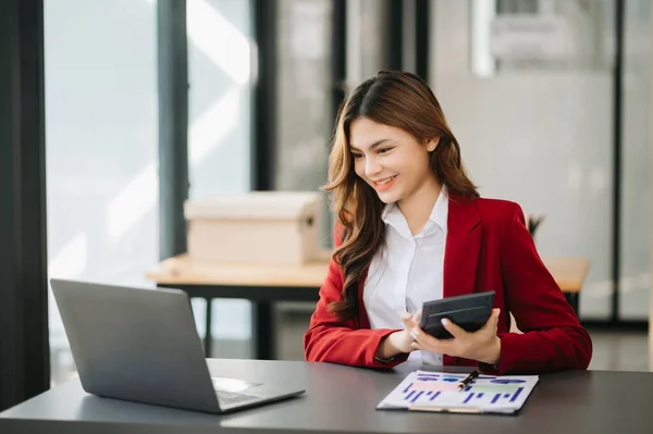 stock image Woman freelancer is working her job on  laptop, Doing accounting analysis report real estate investment data, Financial at modern office