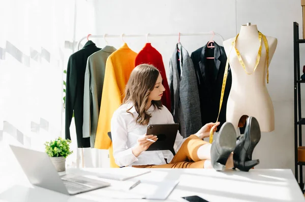 Stock image Caucasian young woman,fashion designer   in office with tablet and laptop 