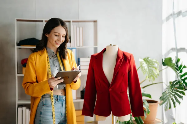 Stock image Fashion designer woman  using  digital tablet computer in modern studio 