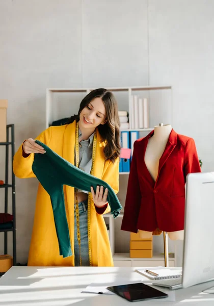 stock image Fashion designer woman  with digital tablet computer in modern studio with clothes