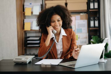 Modern ofiste bilgisayarlı ve tabletli güzel bir kadın.