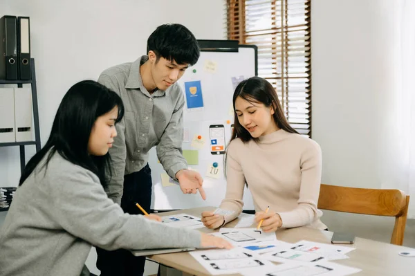 stock image Asian businesspeople meeting in office. Employee brainstorm and work as team, plan and discuss project 