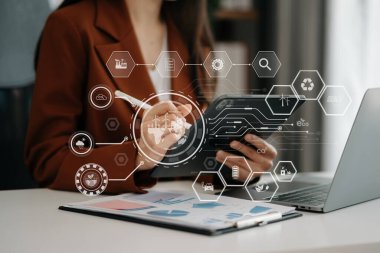 Businesswoman working with reduce CO2 concept with icons, global warming such as reforest green factory recycle and zero carbon dioxide emission concept. with VR icon at office