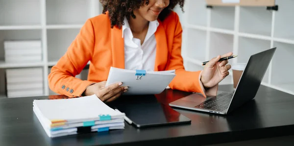 stock image Young African woman with tablet and laptop  working at modern office