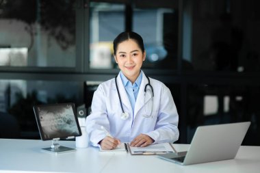 Tıbbi teknoloji konsepti. Ofisteki cep telefonu ve steteskopla çalışan bir doktor.