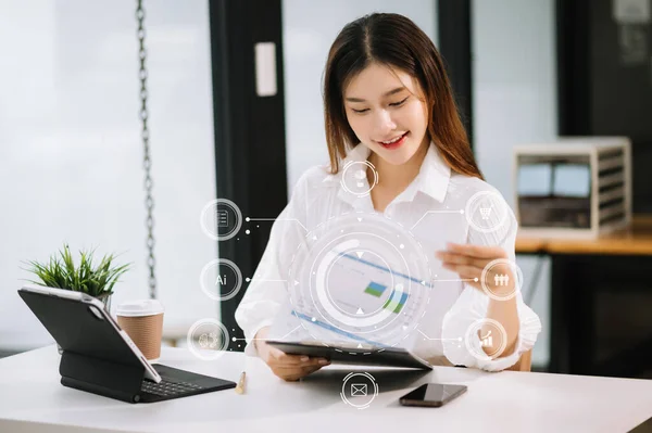 Asian Businesswoman working in the office with VR icon diagram at office in morning light