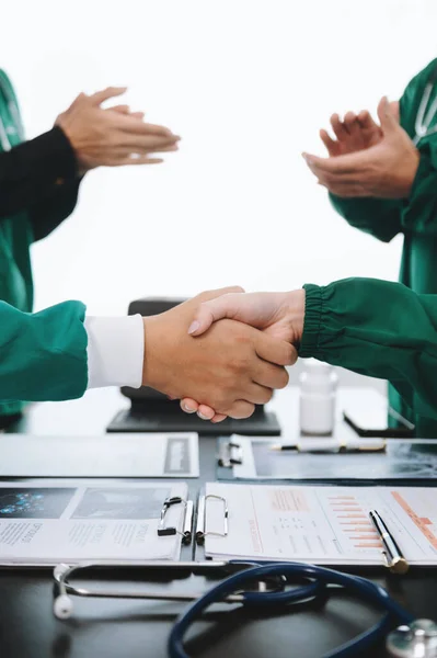 Doctors handshake and partnership in healthcare, medicine or trust for collaboration, unity or support.Team of medical experts shaking hands in teamwork for or success in hospital