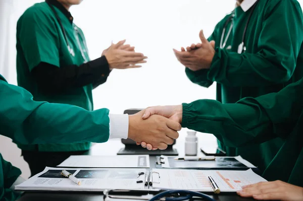 Doctors handshake and partnership in healthcare, medicine or trust for collaboration, unity or support.Team of medical experts shaking hands in teamwork for or success in hospital
