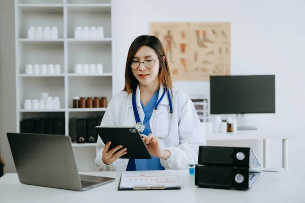 stock image Asian doctor working with modern digital tablet computer interface as medical network concept