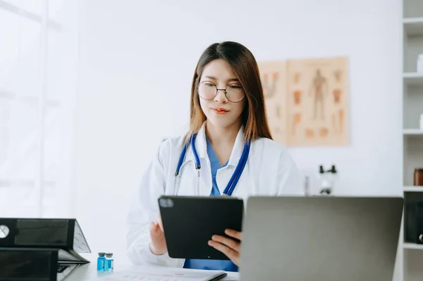 stock image Asian doctor working with modern digital tablet computer interface as medical network concept