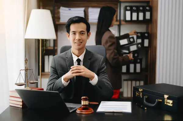 Asian lawyer man working with a laptop in a law office. Legal and legal service concept