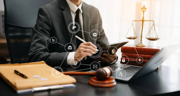 justice and law concept. Male judge in a courtroom  the gavel, working with digital tablet computer on wooden table