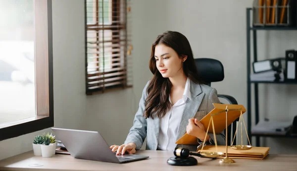 Asian lawyer woman working with a laptop in a law office. Legal and legal service concept.
