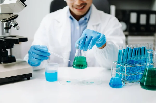 stock image Scientist mixing liquids in chemical lab. Researcher working with test tubes 