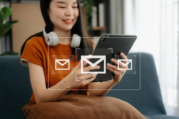 Asian Woman hands using digital tablet and surfing the internet with email icon, email marketing concept, send e-mail or newsletter, online working internet network technology