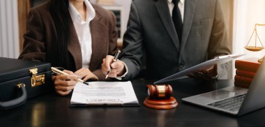 business people discussing contract papers sitting at the table. Concepts of law, advice, legal services