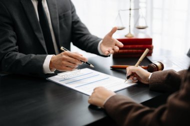 business people discussing contract papers sitting at the table. Concepts of law, advice, legal services