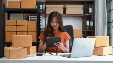Küçük işletme girişimcisi KOBİ 'de çalışan serbest çalışan kadın ofis, çiçek, tablet ve dizüstü bilgisayar, pazarlama, paketleme, e-ticaret konsepti