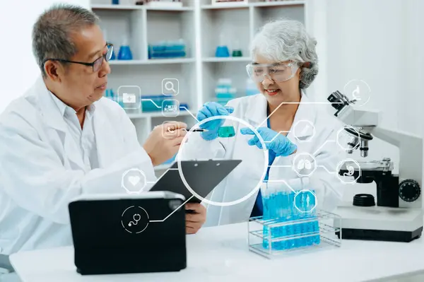 Scientist two Asian senior working in laboratory and ecofriendly science. Scientists analyzing test samples for global warming and tech with virtual icon screen