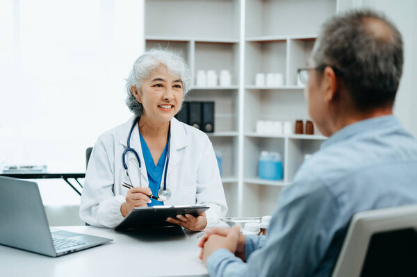 Senior man being examined by a doctor sitting at the table. Medicine and health care concept. in background