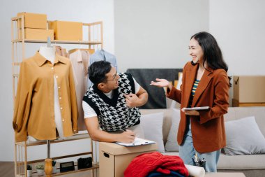 İki profesyonel tasarımcı, dijital tablet kullanarak mağazada son tasarımı tartışıyor ve buluşuyorlar. 