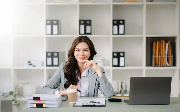 Confident business expert attractive smiling on desk in creative office
