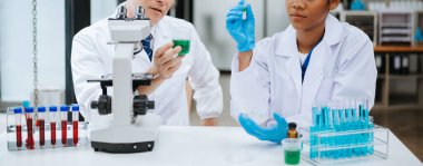 Kimya laboratuvarında kimya sıvılarını karıştıran bilim adamları. Kimya laboratuvarında çalışan bir araştırmacı.