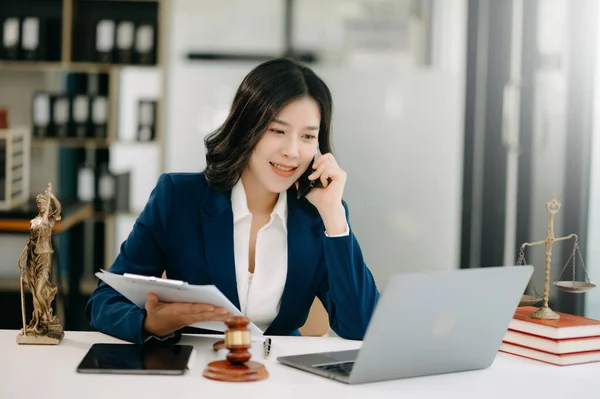 Asian lawyer woman working with in a law modern office. Legal and legal service concept.