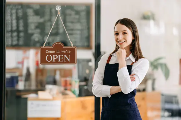 successful small business owner stand in cafe. woman barista cafe owner.