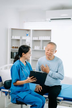  Dost canlısı baş hemşire hasta yatağında dinlenirken onu muayene ediyor.