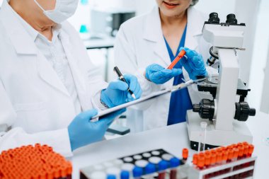 Bilimadamı ekip buluşması ve yazım analizi laboratuvarda küresel ısınma, analitik ve teknoloji için bilimsel örnekler inceler ve analiz eder.