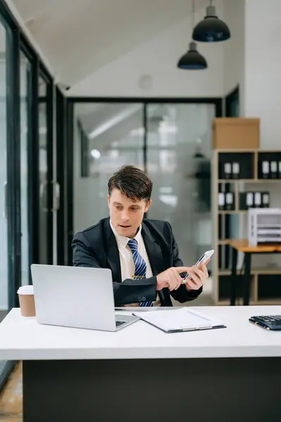 Mature business man watching online webinar training or having virtual meeting, doing market research working in modern office