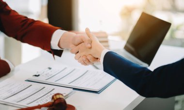 Consultation between a male lawyer and business customer, handshake after good deal agreement, Law and Legal concept.Good service cooperation in office
