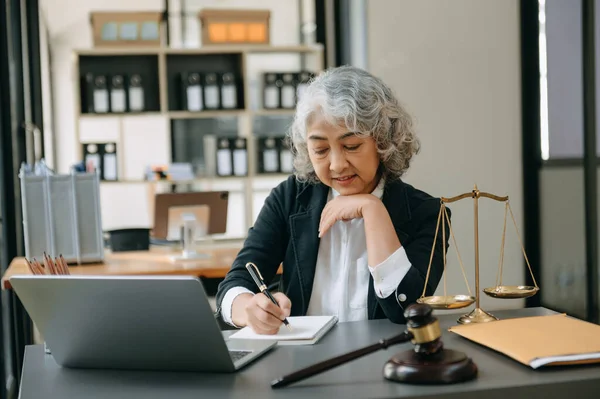 Senior asian woman lawyer working in the office. Advice justice and law concept