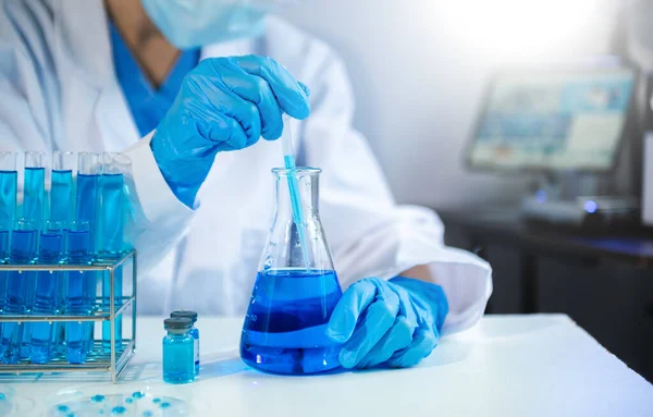 Scientist mixing chemical liquids in the chemistry lab. Researcher working in the chemical laboratory and new chemical substance