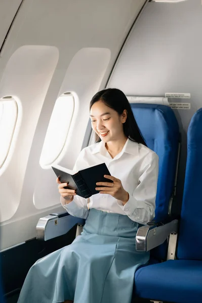 Young Asian executive excels in first class. Travel in style, work with grace