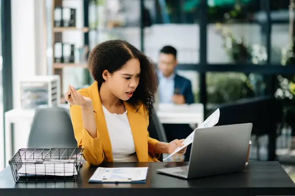 Stock image business woman is stressed, bored, and overthinking, working at the modern office