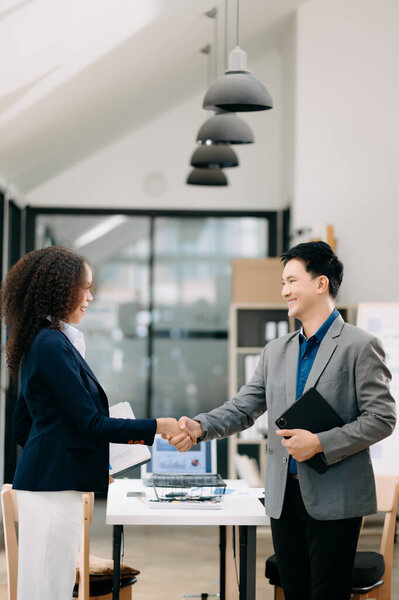 confident business man shaking hands during a meeting in the office, success, dealing, greeting and partner in sun light