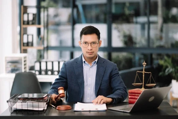 Asian man lawyer working in the office, Advice justice and law concept.