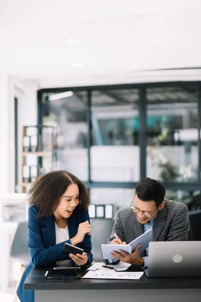 stock image Businesswoman leading team meeting and using laptop computer with financial in co-working office